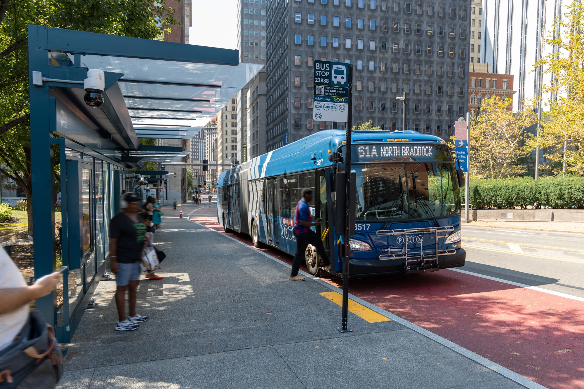 A rider boarding the front door of a PRTX bus at the University Line's Steel Plaza Station in downtown Pittsburgh in August 2025. Riders will be able to board at any door when the University Line fully opens in 2027. 